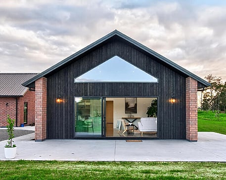 Red brick home with burnt Japanese cedar feature gable end by Whitechurch Construction, Te Awamutu builders.
