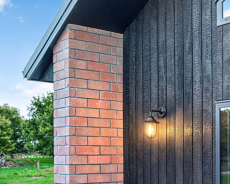 Red brick home with burnt Japanese cedar feature gable end by Whitechurch Construction, Te Awamutu builders.