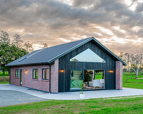 Red brick home with burnt Japanese cedar feature gable end by Whitechurch Construction, Te Awamutu builders.