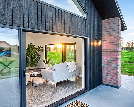Red brick home with burnt Japanese cedar feature gable end by Whitechurch Construction, Te Awamutu builders.