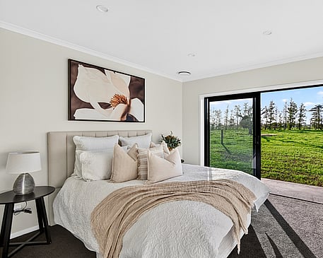 filled neutral coloured main bedroom in Gordonton Road new build by Whitechurch Construction, Te Awamutu builders. lounge with modern large white comfy lounges suite in Collinson Street, Pirongia new home, by Waikato residential builders Whitechurch Construction Limited.