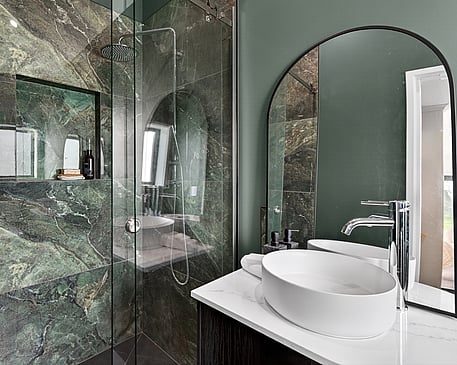 Modern bathroom with forest green wall paired with deep green marble tiled shower wall in Gordonton Road new build by Whitechurch Construction, Te Awamutu builders.