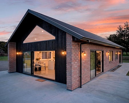 Red brick cladded home with burnt Japanese cedar feature gable. By Whitechurch Constuction, Te Awamutu Builders.