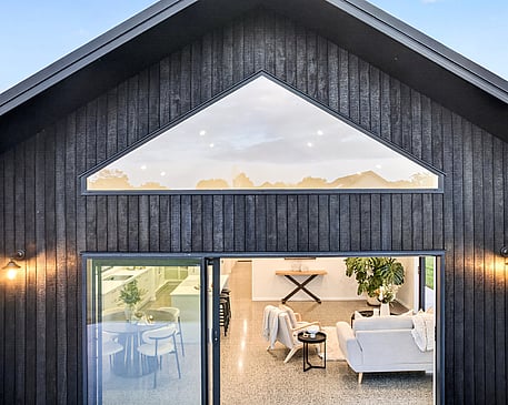 Red brick cladded home with burnt Japanese cedar feature gable. New build by Whitechurch Construction, Te Awamutu builders.