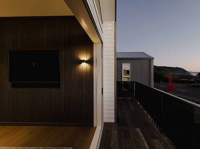 Living area opening onto deck with view of Lake Taupo