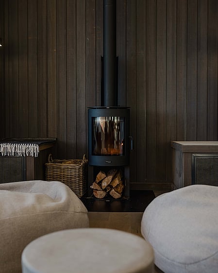 Fireplace with dark timber feature wall and beanbags