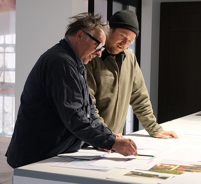 Architect and builder reviewing plans for architectural home in New Zealand