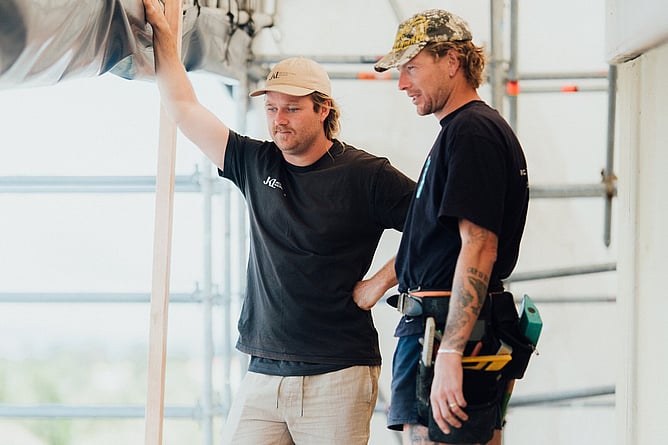 Architectural builder reviewing custom home construction on site