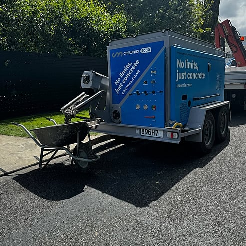 Crewmix CM1000 pouring concrete into wheel barrow at residential pour