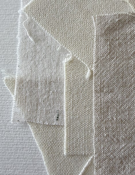 detail of layered tonal linen and cotton fragments, showing weave texture and soft frayed edges