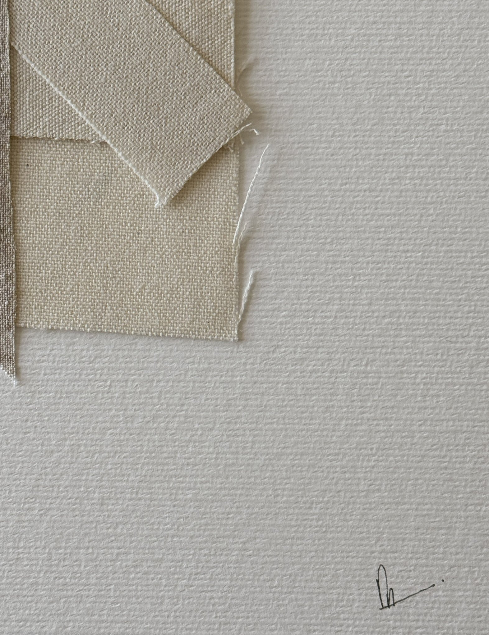 close-up image of soft white fabriano surface texture, layered cotton fragments with soft frayed edges and handwritten signature in lower right corner