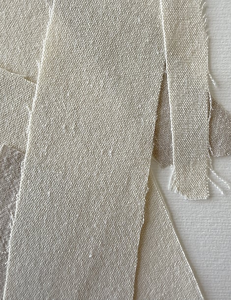 detail image of layered neutral-toned linen and cotton fragments, showing weave texture and soft frayed edges