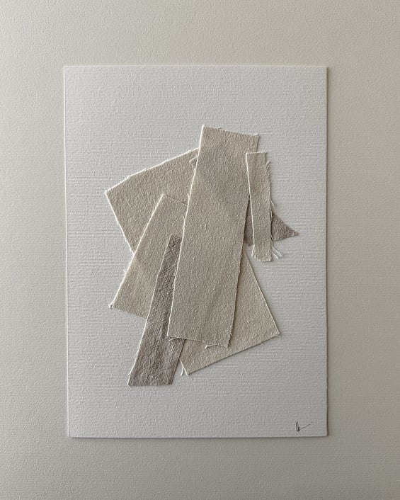 full image of layered collage of neutral-toned linen and cotton fragments on ivory fabriano, showing soft frayed edges and handwritten signature in lower right corner
