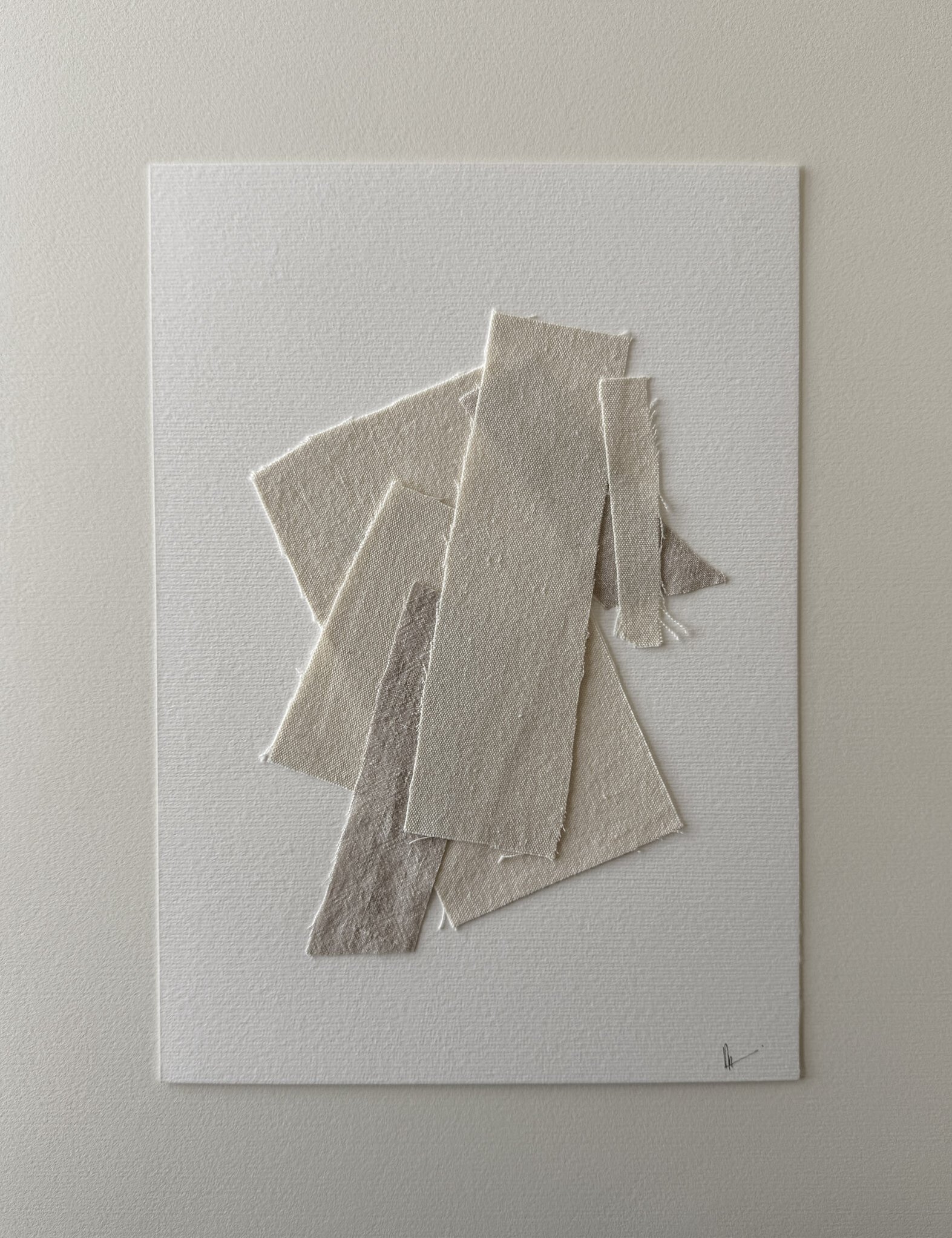 full image of a layered collage of neutral-toned linen and cotton fragments on soft white fabriano, showing soft frayed edges, varied weave textures and handwritten signature in lower right corner