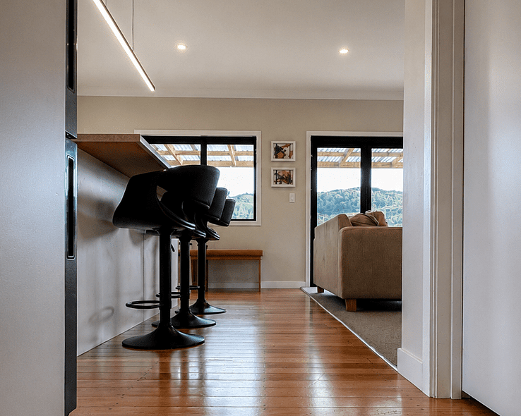 Image of white weatherboard home with new outside decking. Renovated by Coull Builders. Otorohanga, Waikato.
