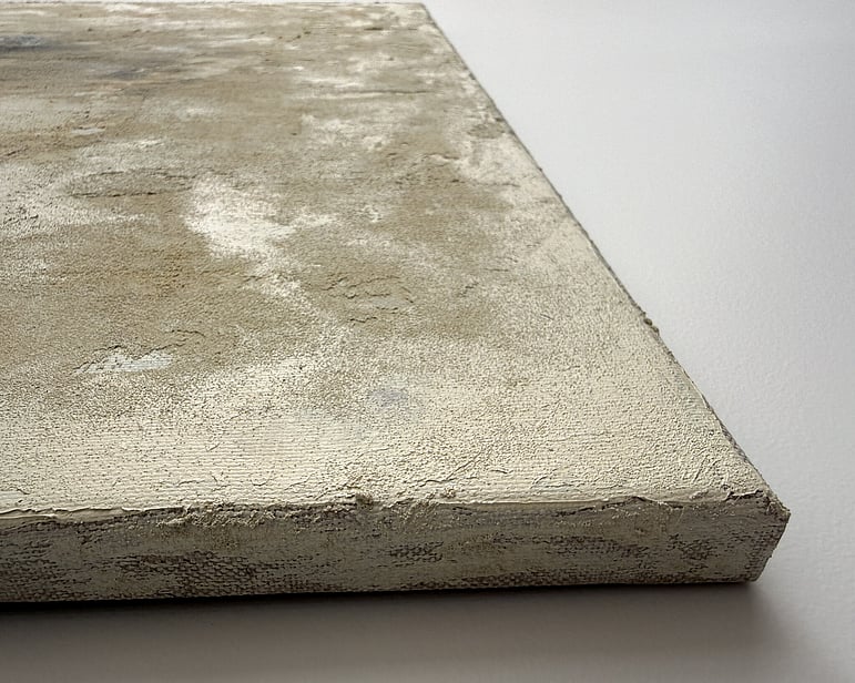 side view of canvas showing granular mineral surface, raised texture and canvas depth