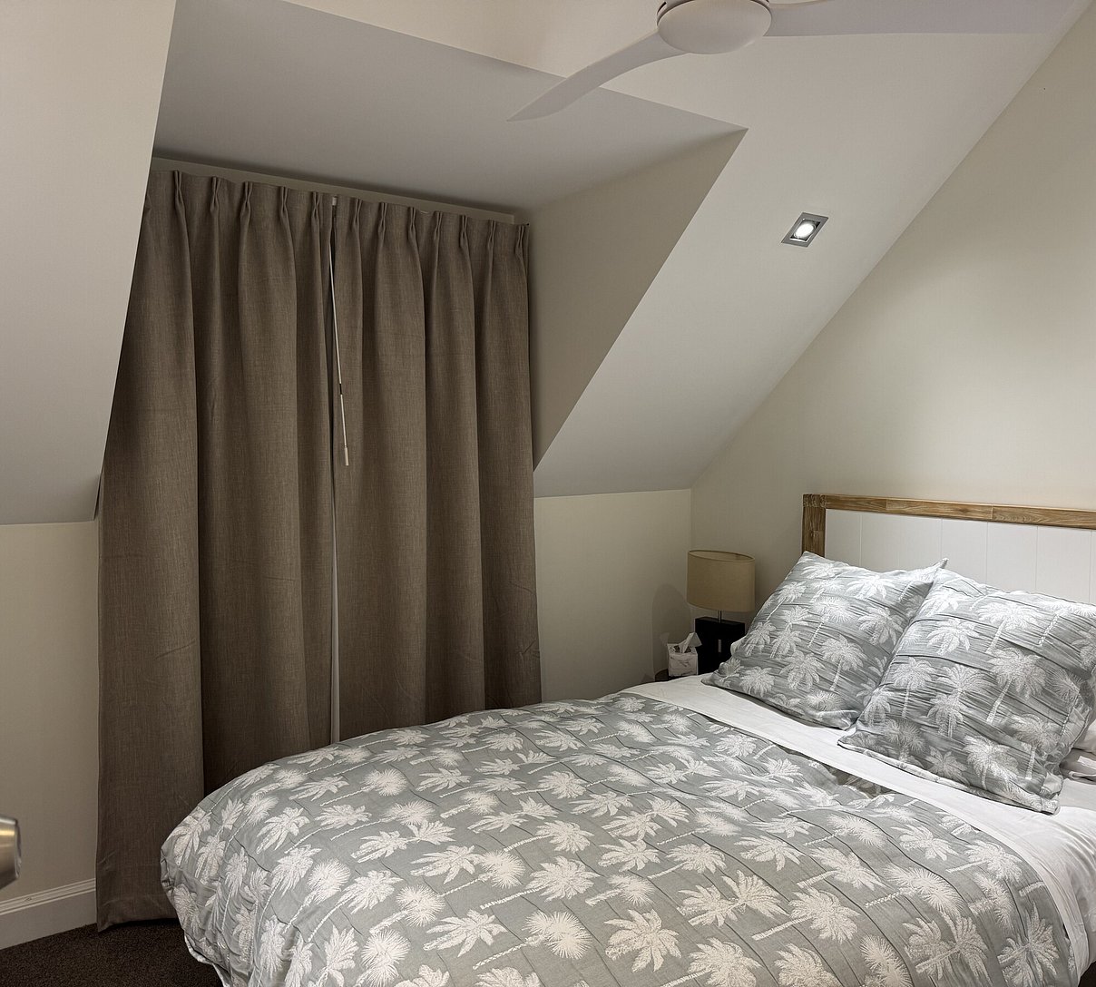 Spacious upstairs queen bedroom featuring a cooling ceiling fan at Crab Shack Cottage Russell Cottages
