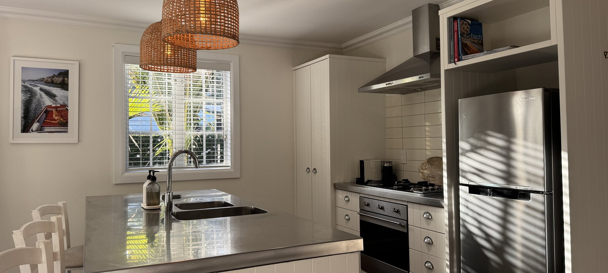 Modern kitchen island and breakfast bar at Crab Shack Cottage, a premium holiday home within Russell Cottages