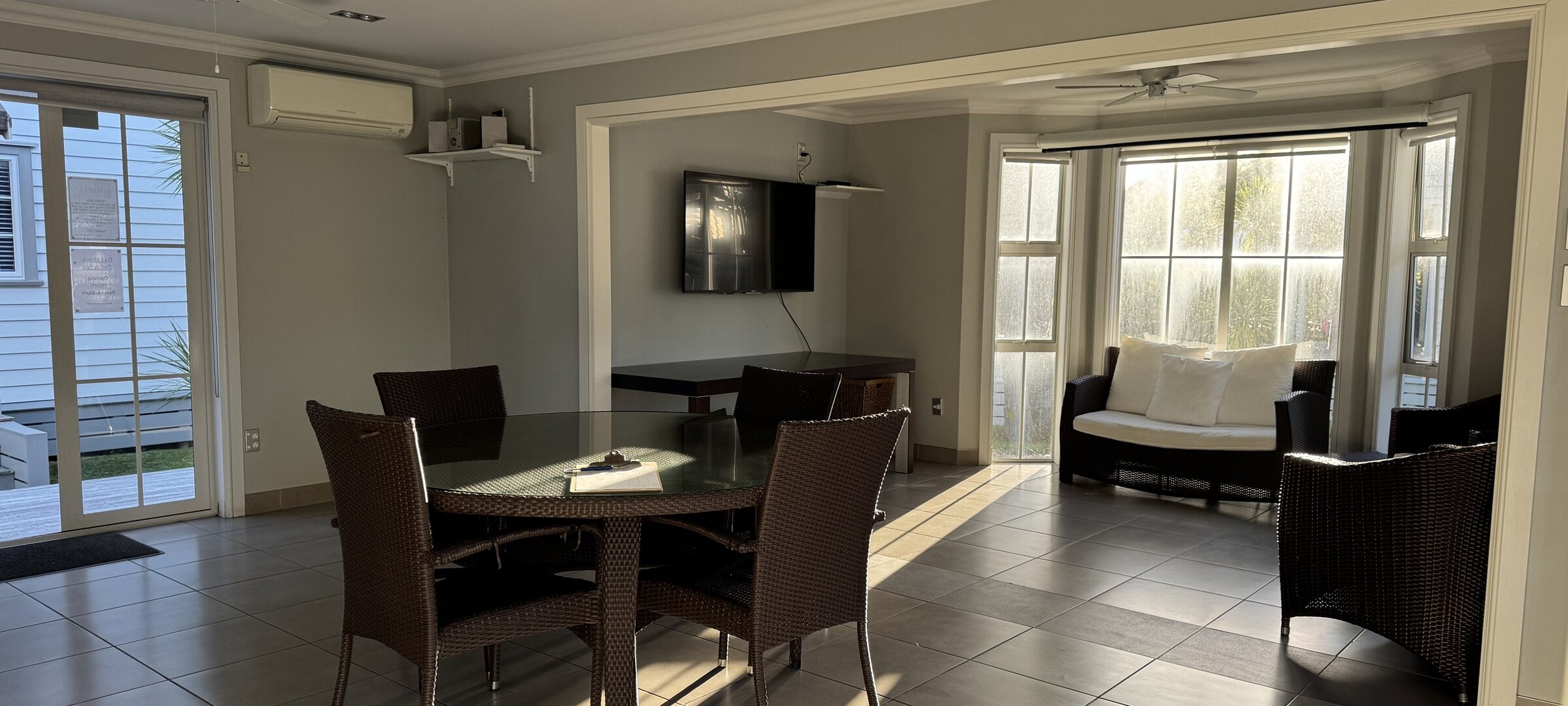 shared pool house social space with ice maker and dual BBQs for guest use