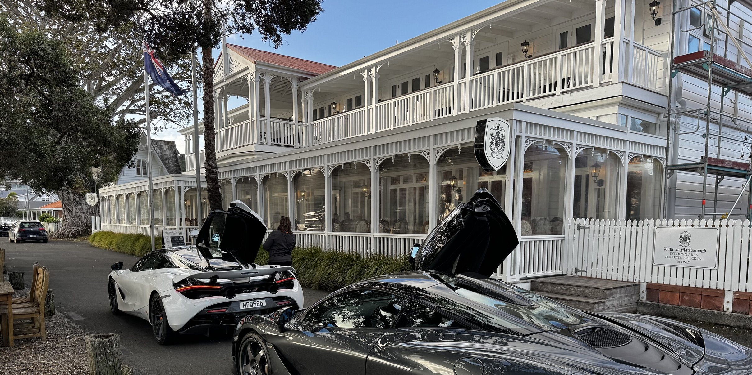 Two luxury McLaren sports cars parked outside the historic Duke of Marlborough Hotel on the Russell waterfront near Crab Shack Cottage