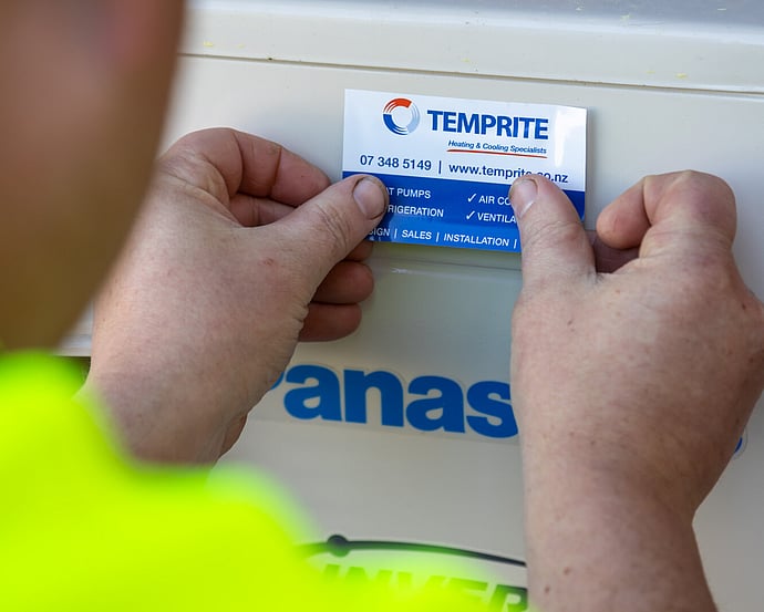 Technician applying a Temprite service sticker after BWOF maintenance
