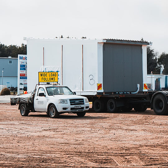 TDM Transport staff member moving modular homes in Hamilton, New Zealand 