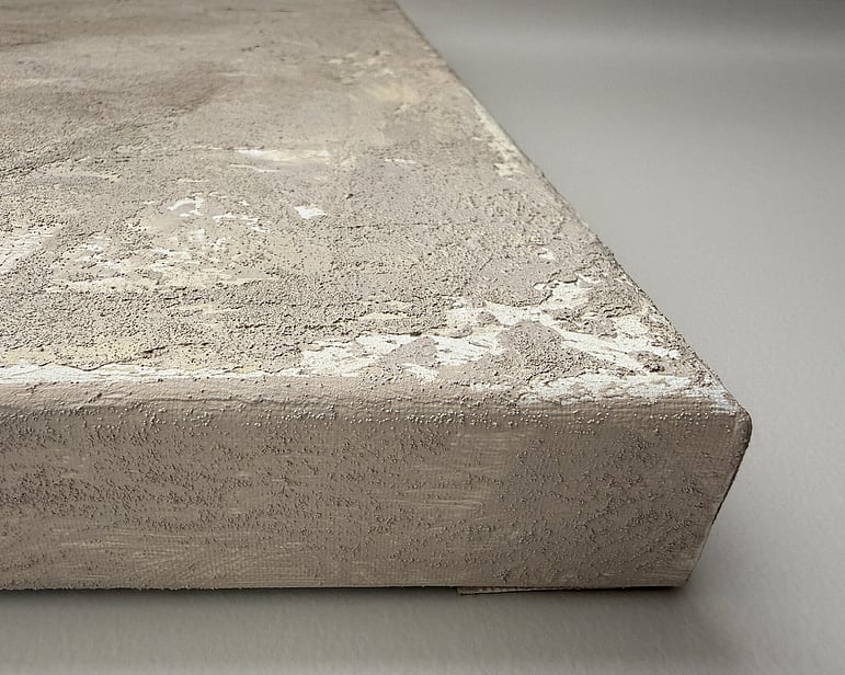 side view of canvas showing granular mineral surface, raised texture, exposed pockets of linen and canvas depth