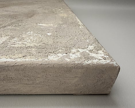 side view of canvas showing granular mineral surface, raised texture and canvas depth