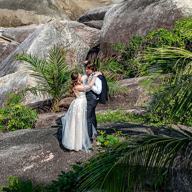 https://unsplash.com/photos/a-bride-and-groom-standing-on-a-rock-by-the-ocean-KamEDWhpFNU?utm_source=unsplash&utm_medium=referral&utm_content=creditShareLink