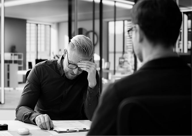 Business owner reviewing employee documentation during a disciplinary process