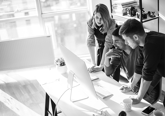 Small business team collaborating at a desktop computer