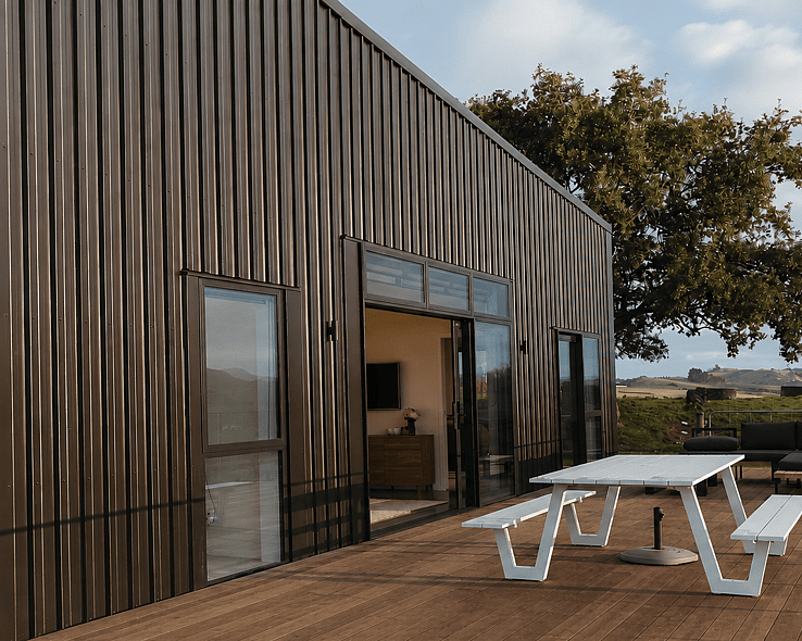 Image of dark cladded new build home with rural outlooks. Built by Coull Builders in the Waikato.