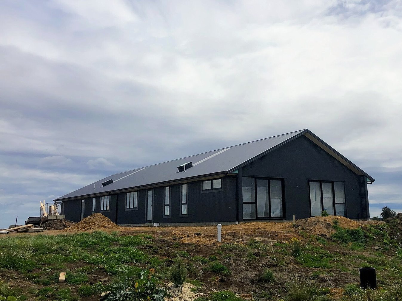 Image of dark exterior cladded new build home with Waikato rural outlooks. Built by Otorohanga builders, Coull Builders.