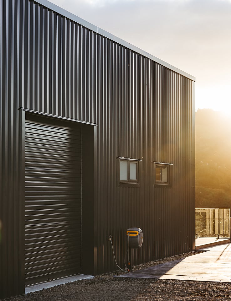 Image of dark exterior cladded new build home with Waikato rural outlooks. Built by Otorohanga builders, Coull Builders.