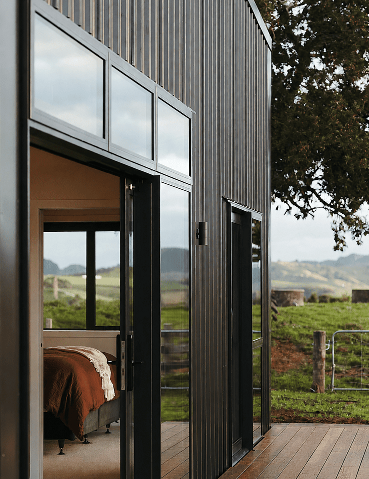 Image of dark exterior cladded new build home with Waikato rural outlooks. Built by Otorohanga builders, Coull Builders.
