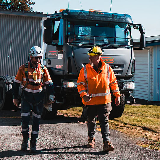 TDM Transport team members in hi-vis beside the TDM 07 truck, New Zealand