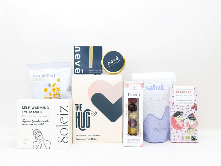 KYND Care Package Gift Box — NZ comfort gift box with HUG hot and cold gel pack, Nevé candle, bath soak, eye masks, Better Tea blooming tea balls and Bennetto chocolate in signature white premium gift box