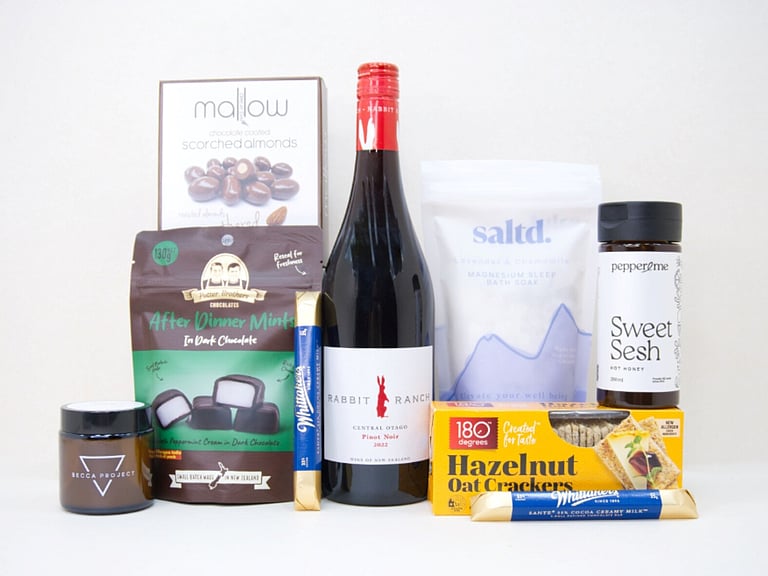 The After Dinner Mint Gift Box featuring Rabbit Ranch Pinot Noir, Becca Project chocolate, Potter Brothers After Dinner Mints, Great Day Mallow scorched almonds, Sweet Sesh honey, artisan crackers, and Saltd bath soak in a premium KYND gift box.