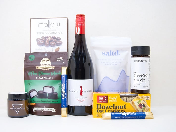The After Dinner Mint Gift Box featuring Rabbit Ranch Pinot Noir, Becca Project chocolate, Potter Brothers After Dinner Mints, Great Day Mallow scorched almonds, Sweet Sesh honey, artisan crackers, and Saltd bath soak in a premium KYND gift box.