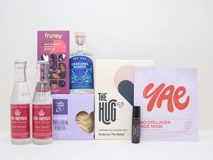 The Evening Reset Gift Box featuring Dancing Sands Gin, Yae face mask, The Hug tea, Molly Woppy cookies, and Fruney chocolate in a premium KYND gift box.