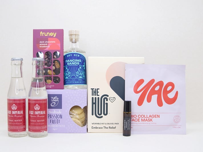 The Evening Reset Gift Box featuring Dancing Sands Gin, Yae face mask, The Hug tea, Molly Woppy cookies, and Fruney chocolate in a premium KYND gift box.