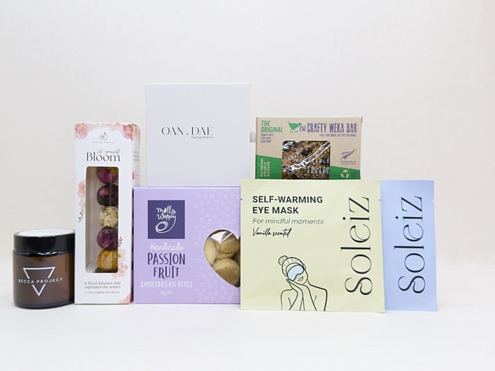 Mindful Moment self-care gift box with Soleiz eye masks, herbal tea balls, OAN DAE wish kit, Molly Woppy cookies, wellness products, and wholesome treats, designed to encourage rest, mindfulness, and everyday self-care
