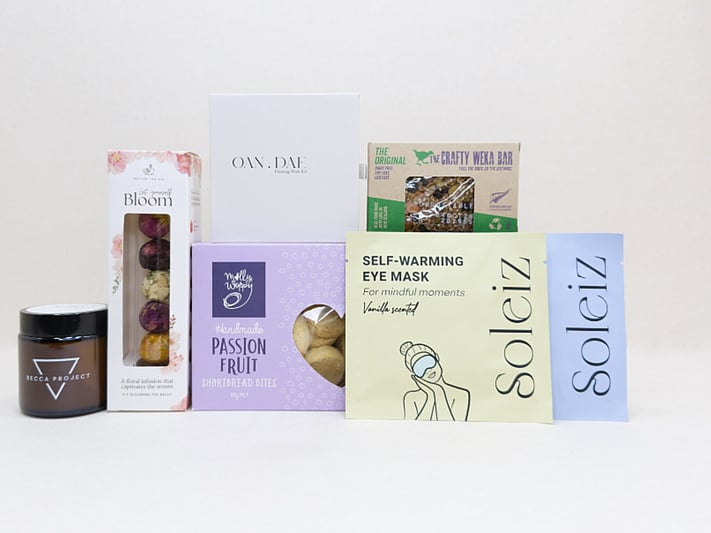 Mindful Moment self-care gift box with Soleiz eye masks, herbal tea balls, OAN DAE wish kit, Molly Woppy cookies, wellness products, and wholesome treats, designed to encourage rest, mindfulness, and everyday self-care