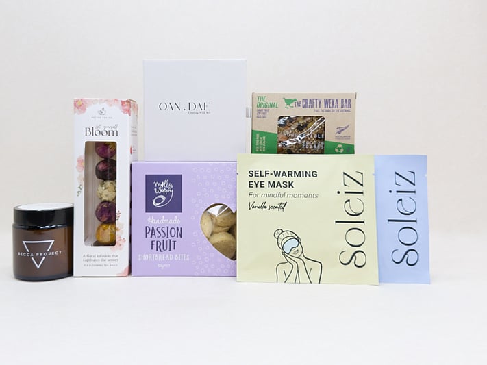 Mindful Moment self-care gift box with Soleiz eye masks, herbal tea balls, OAN DAE wish kit, Molly Woppy cookies, wellness products, and wholesome treats, designed to encourage rest, mindfulness, and everyday self-care
