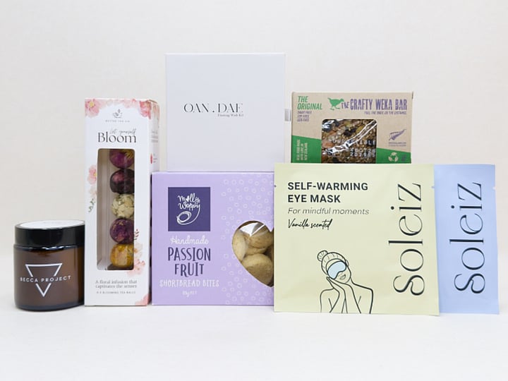 Mindful Moment self-care gift box with Soleiz eye masks, herbal tea balls, OAN DAE wish kit, Molly Woppy cookies, wellness products, and wholesome treats, designed to encourage rest, mindfulness, and everyday self-care