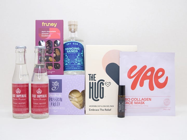 The Evening Reset Gift Box featuring Dancing Sands Gin, Yae face mask, The Hug tea, Molly Woppy cookies, and Fruney chocolate in a premium KYND gift box.