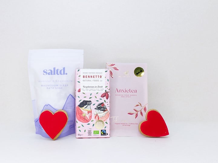Rest & Restore self-care gift box featuring Anxietea tea, Saltd bath salts, Bennetto chocolate, and sweet treats, beautifully packaged for gifting.