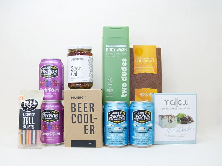 Spoil Him Gift Box featuring Good George beer, Two Dudes shower gel, Great Day Mallow treats, and a HUSKI beer cooler in a premium KYND gift box.