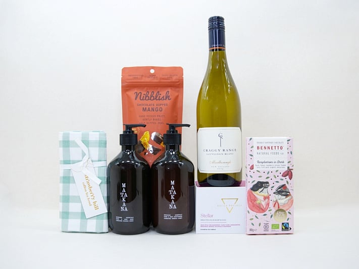 Luxury Wine Gift Box featuring Craggy Range wine, Matakana Botanicals hand wash, Becca Project chocolate, Bennetto chocolate, and a Strawberry Hill tea towel in a premium KYND gift box.