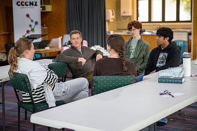 Miles Davison (second from left) leads a small group discussion with young people at First Training, unpacking the session on 'Hearing God's Voice'.